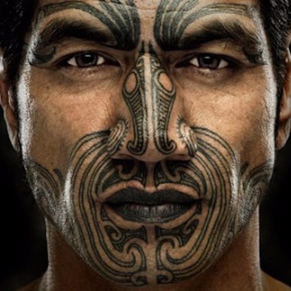 Imagem de um homem com uma tatuagem Maori Nativa no rosto